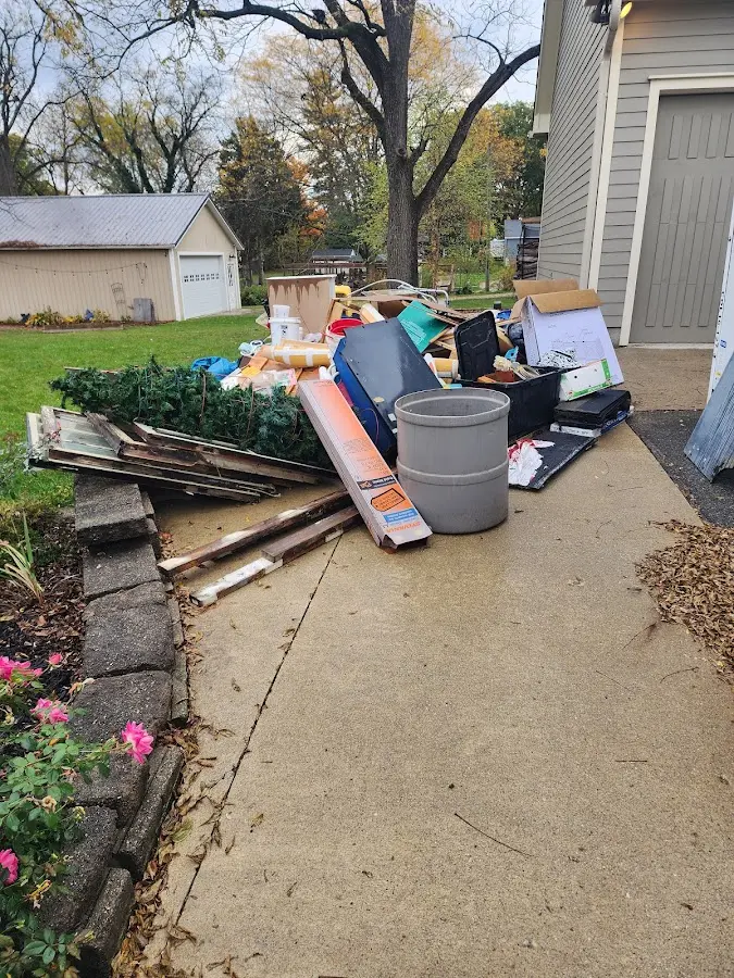 Dumpster being loaded with debris for 10 Yard Dumpster Rental in Collinsville